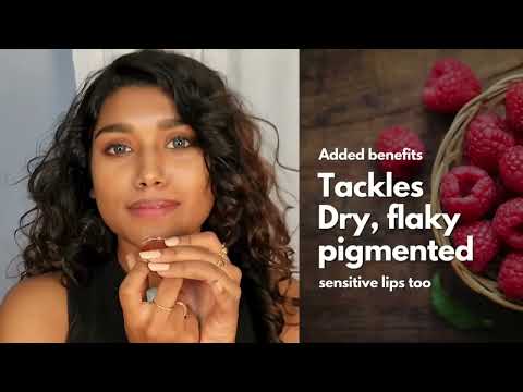 Woman applying the hydrating lip tint for a sheer, buildable coral color.